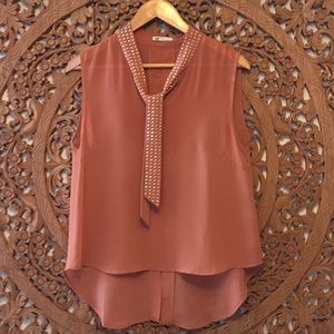 Dark peach colored sheer sleeveless blouse